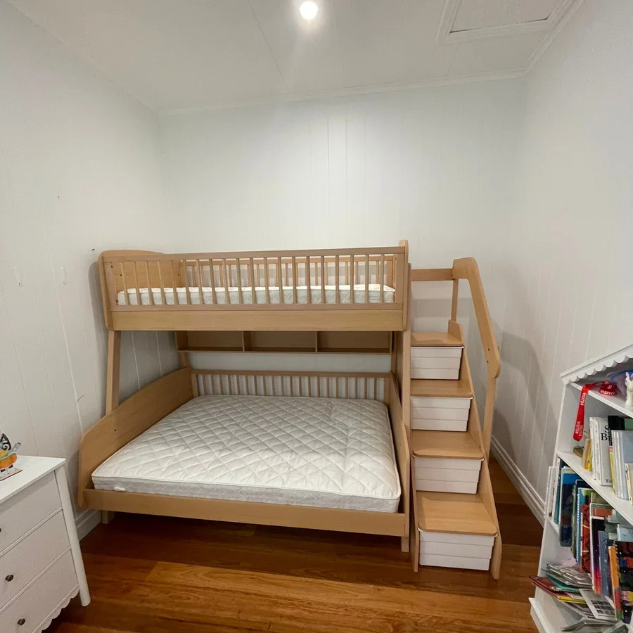 Timber bunk bed with stair access assembled in a kid's bedroom