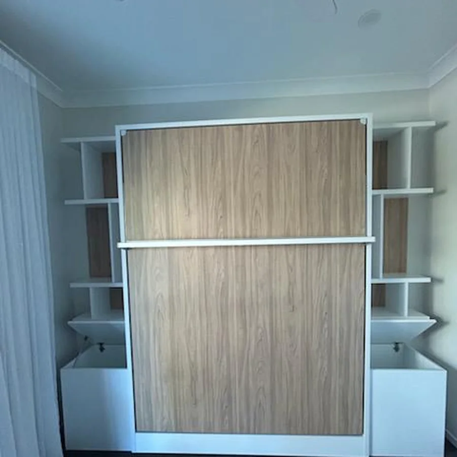 Timber-fronted wall bed assembled with surrounding shelving